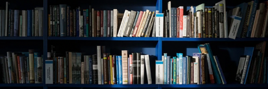 Blue bookshelf with books under a spot light